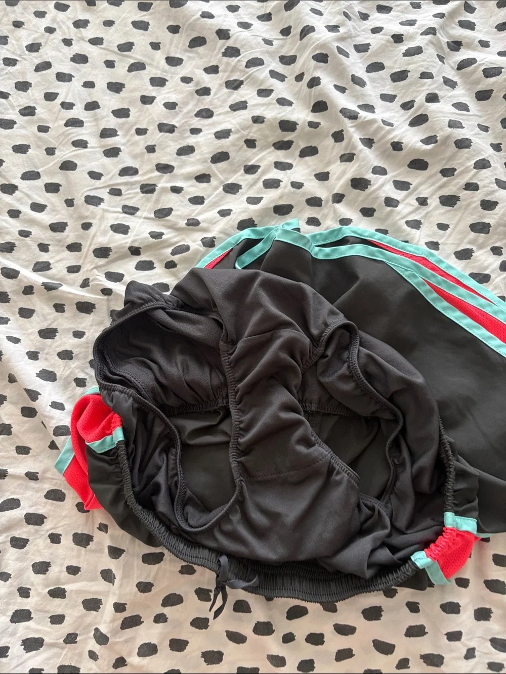 Nike Black Athletic Shorts with Teal Trim and Coral Side Panels